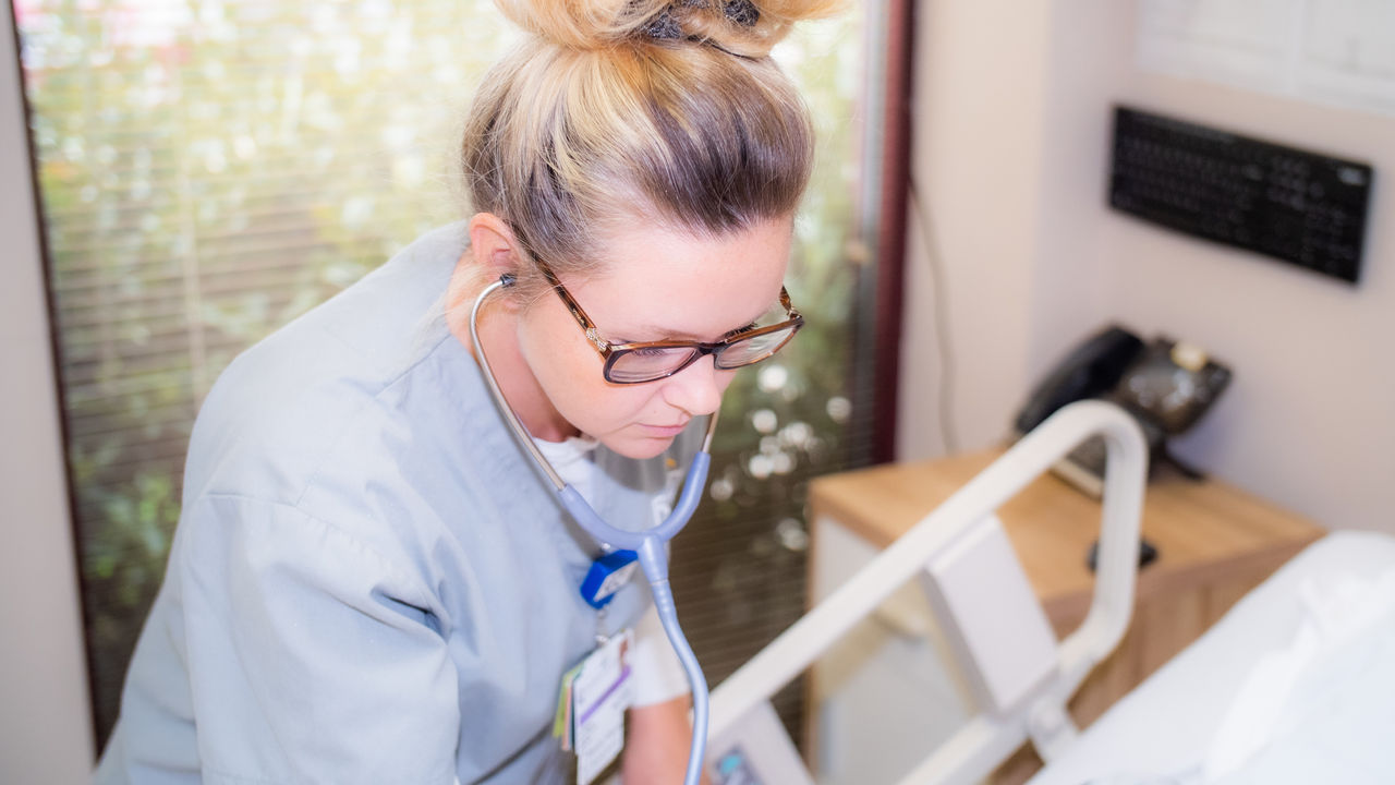 Nurse caring for patient in clinical setting